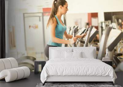 Young woman training in the gym Wall mural