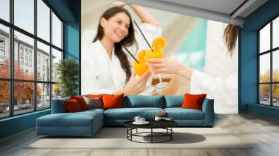 Young women relaxing by the pool Wall mural