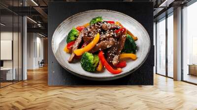 asian food teriyaki beef with red and yellow bell peppers broccoli and sesame seeds Wall mural