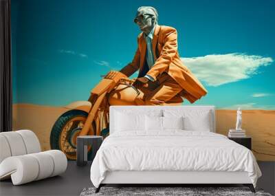 A person in a bright orange outfit riding a scooter in a vast desert landscape. Wall mural