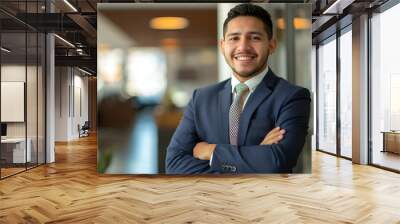 Smiling elegant confident young professional Latino hispanic business man , male proud leader, smart Latin businessman lawyer or company manager executive looking at camera standing in office Wall mural