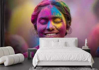 Vivid close-up portrait of an Indian woman covered in colorful Holi powder, smiling with eyes closed, capturing the festive joy and cultural vibrancy of the Holi festival Wall mural