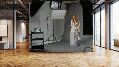 Young blonde woman model at photo studio with professional equipment Wall mural