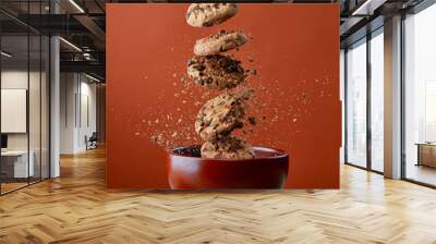 Chocolate chip cookies falling in bowl Wall mural