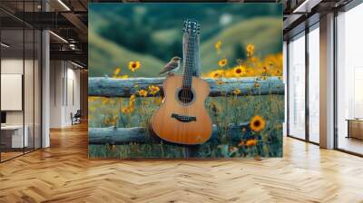 A guitar rests on a wooden fence with a small bird perched on the neck, surrounded by yellow wildflowers. Wall mural