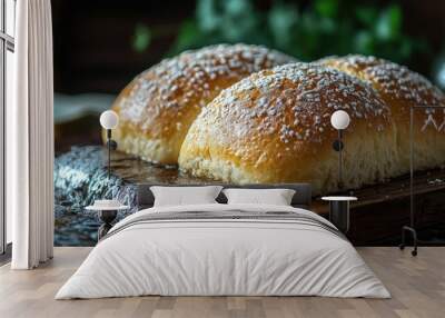 Closeup of two freshly baked bread rolls on a wooden cutting board sprinkled with sugar. Wall mural