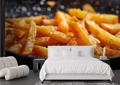 Crispy golden fries sizzling in a frying pan, ready to be served. Wall mural