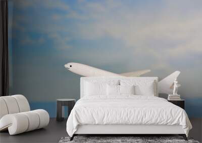 Airplane flying in the blue sky with - Traveler's Airlines plane toy Wall mural