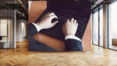 Businessman working on keyboard computer laptop man sitting on the table and using internet technology at workplace in office - Male hand typing on keyboard concept Wall mural