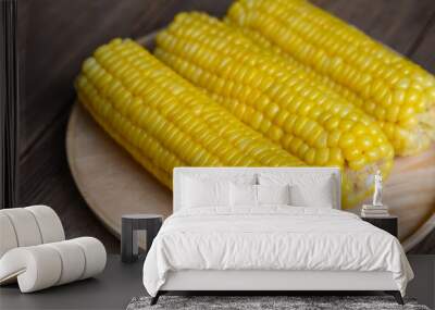 cooked sweet corn on wooden plate background, ripe corn cobs steamed or boiled sweetcorn for food vegan dinner or snack Wall mural