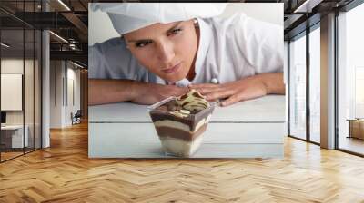 Italian young woman pastry chef checks tiramisufocus on cake Wall mural