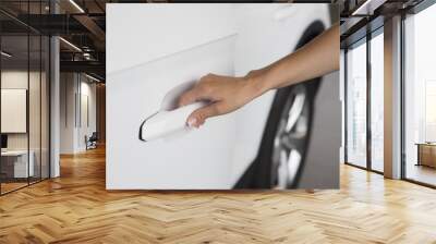 Woman hand on open the new white car door background Wall mural