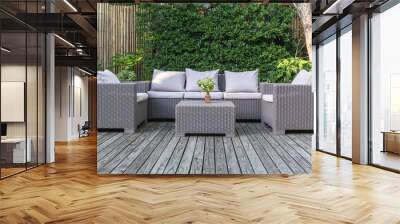 Large terrace patio with rattan garden furniture in the garden on wooden floor. Wall mural