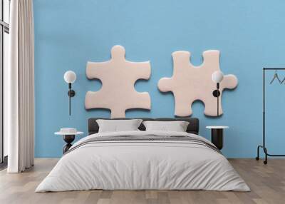 Two white details of puzzle on blue background Wall mural