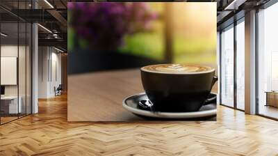 Nice cup of fresh brewed coffee with beautiful latte art on wooden table in cafe with copy space. Coffee break recreation relaxation Wall mural