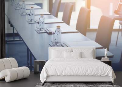 Plastic water bottles, Drinking glasses with pencil and white papers setup on the table prepared for seminar or business meeting in the hotel conference room Wall mural