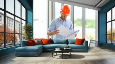 portrait of construction engineer manager workers in orange hardhat and looking layout plan. posing  Wall mural