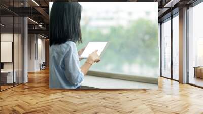 woman using a tablet pc with blank white desktop screen Wall mural