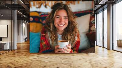 joyful young woman savoring a cup of coffee at home laughing on a cozy autumn day lifestyle portrait Wall mural