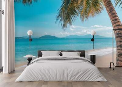 Coconut palms swaying on tropical beach shoreline picture Wall mural