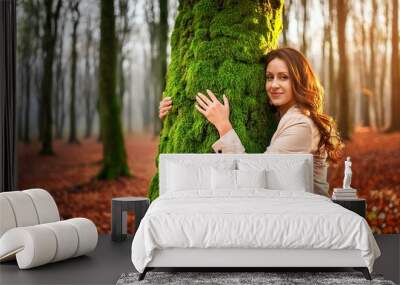 person in the woods, person holding hands, portrait of a woman in the forest, person in the park, Environment and nature care people concept activity. One woman hugging and embracing green musk covere Wall mural