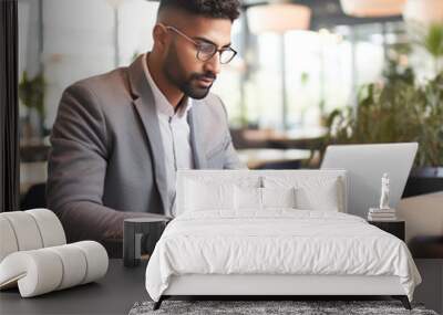 young businessman using laptop at office Wall mural