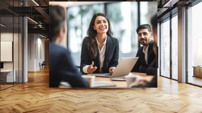 Young businesswoman discussing with staff at meeting Wall mural