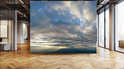 Aerial view at high altitude of dense puffy cumulus clouds flying in evening Wall mural