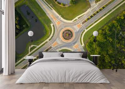 Aerial view of road roundabout intersection with moving cars traffic. Rural circular transportation crossroads Wall mural