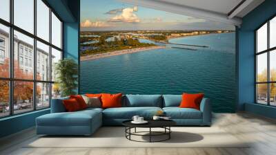 Aerial view of sea shore near Venice, Florida with white yachts at sunset floating on sea waves. North and South Jetty on Nokomis beach. Motor boat recreation on ocean surface Wall mural