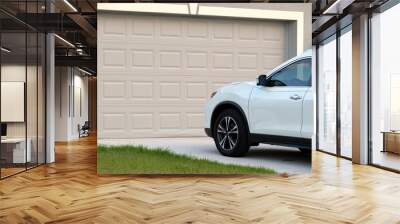 Car parked in front of wide garage double door on concrete driveway of new modern american house Wall mural