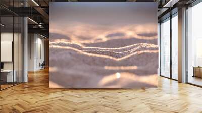 Close up of clean yellow sand surface covering seaside beach illuminated with evening light. Travel and vacations concept Wall mural