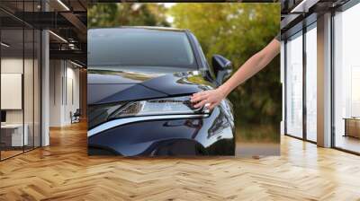 Female driver hands checking headlight of her new car. Purchase of vehicle concept Wall mural