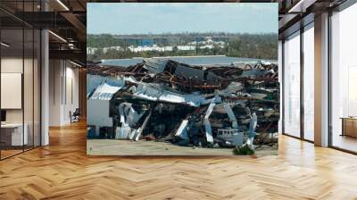 Hurricane Ian destroyed boat station in Florida coastal area. Natural disaster and its consequences Wall mural