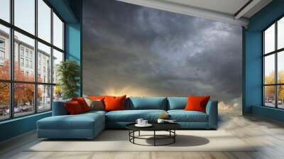 Sunset sky covered with dramatic storm puffy clouds before rain. Wall mural