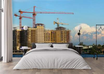 Tower lifting cranes at high residential apartment buildings construction site. Real estate development Wall mural