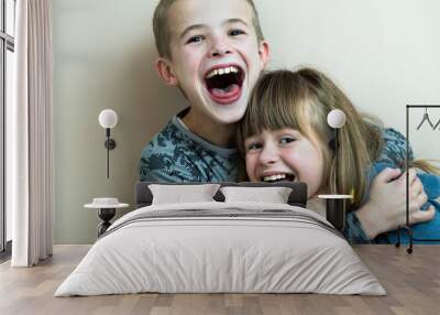 Two children boy and girl fooling around having fun together. Happy childhood concept. Wall mural