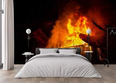 Wooden house or barn burning on fire at night. Wall mural