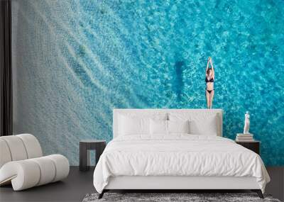 Aerial view of a girl on ocean on Bali, Indonesia. Vacation and adventure. Turquoise water. Top view from drone at ocean, azure watre and relax girl. Travel and relax - image Wall mural