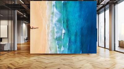 Aerial view of a girl on the beach. Beach and turquoise water. Top view from drone at beach, blue sea and relax girl. Travel and relax - image Wall mural