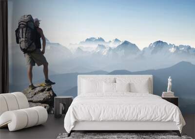 Tourist in mountain peak. Active life concept Wall mural