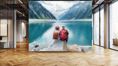 Travelers couple look at the mountain lake. Travel and active life concept with team. Adventure and travel in the mountains region in the Austria Wall mural