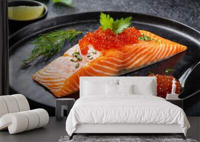 Japanese cuisine. Salmon fillet with caviar on black plate.  Wall mural