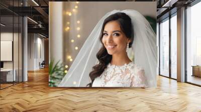 Woman in a white dress with a veil, model posing. Wall mural