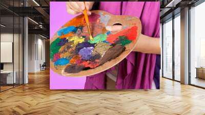 Artist Painting with Palette and Brush in Studio Wall mural