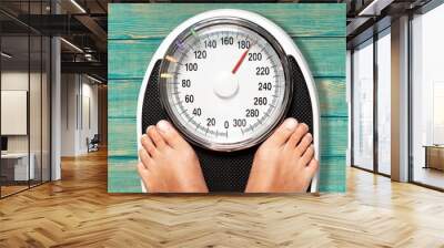 Bare female feet standing on bathroom scale Wall mural