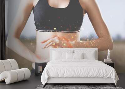 Beautiful woman's slim stomach, and hands showing a balance in her microflora Wall mural