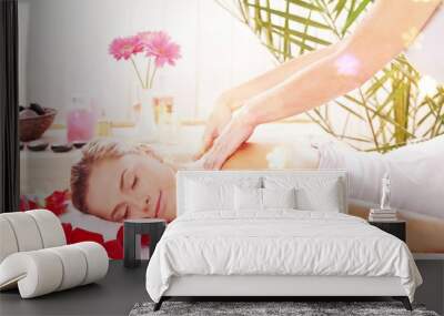 Beautiful young woman relaxing with massage at beauty spa Wall mural