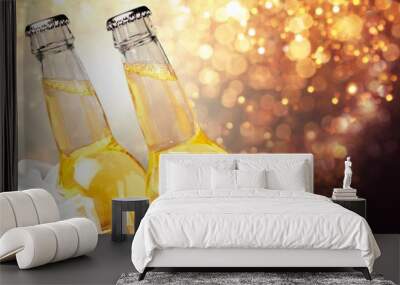 Bottles of beer in ice on blurred background Wall mural