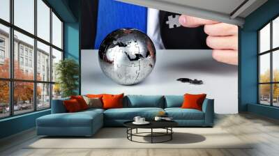 Business man solving a world puzzle - concept of business Wall mural